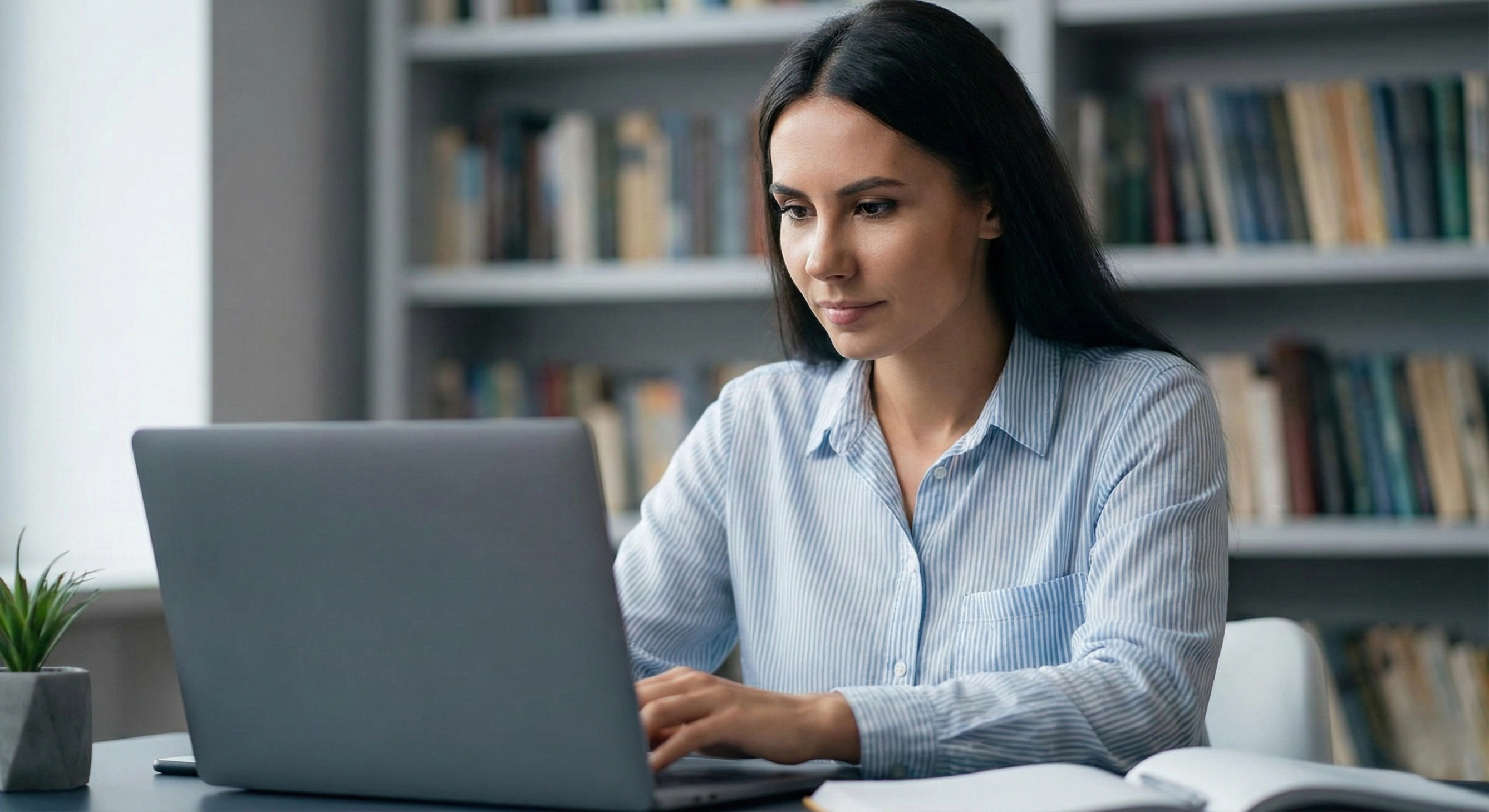 A person with single-pointed focus working on a laptop, illustrating the principle of concentrated action.