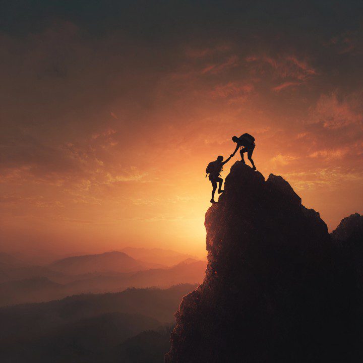 Climbing to the Top – Helping Hand on a Mountain Peak at Sunrise -  PresentationGO